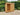 Solid oak log store in a garden setting
